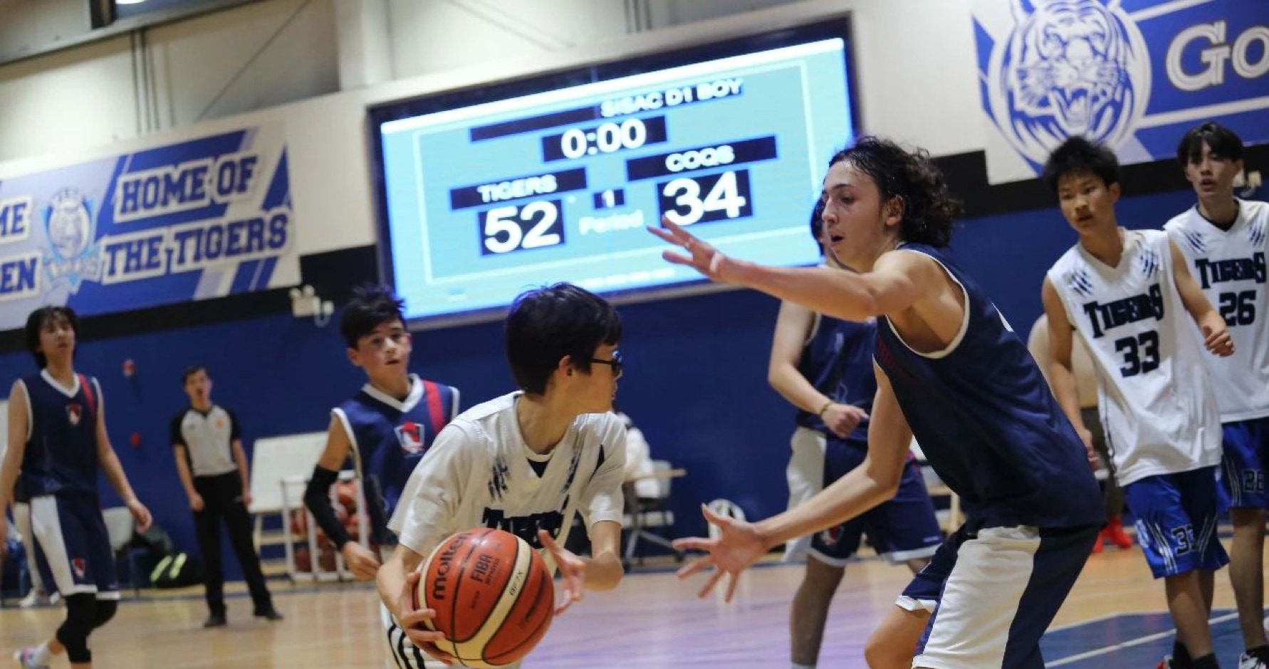 he Western International School of Shanghai (WISS Tigers) recently sparred with the Shanghai French School (LFS Coqs) in an exhilarating high school boys' basketball game. The Tigers emerged triumphant with a final score of 52 to 34, demonstrating their unwavering determination and skill on the court.  From the opening tip-off, it was evident that the LFS Coqs were a formidable opponent. Their tenacity and competitive spirit challenged the Tigers at every turn, forcing them to bring their A-game. The Coqs showcased exceptional ball-handling skills, precision shooting, and effective defensive strategies to keep the Tigers on their toes. They displayed great teamwork and coordination, executing plays with precision and determination. 